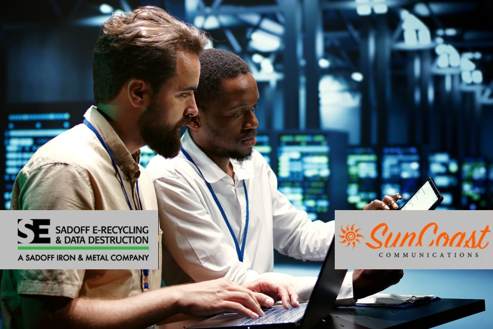 Two men reviewing computers in a data center and Sadoff +SunCoast logo