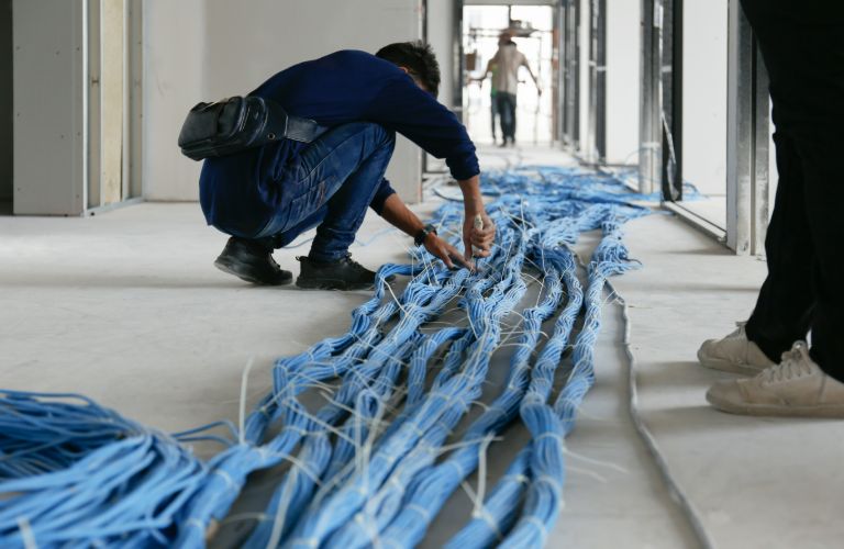 a man working on network cables
