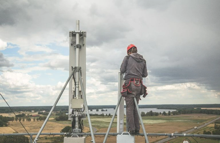 Man working on old telecom equipment