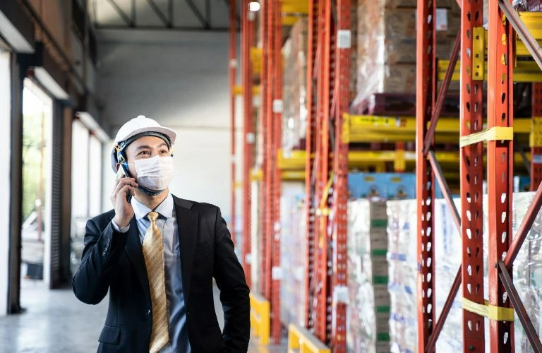 business man walking through a warehouse