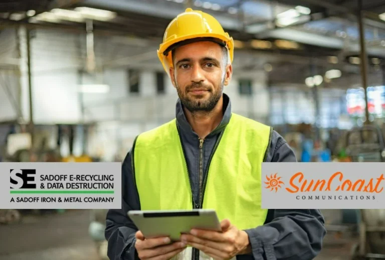 Man in high vis in telecom warehouse with the Sadoff and SunCoast logos